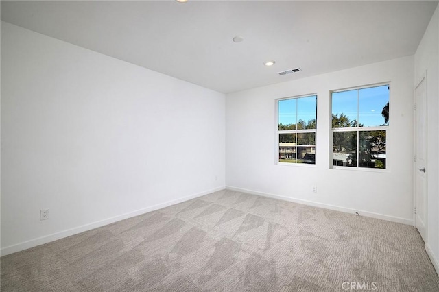 empty room featuring light carpet