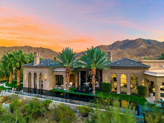 back house at dusk with a mountain view