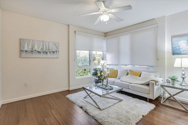 living room with wood-type flooring and ceiling fan