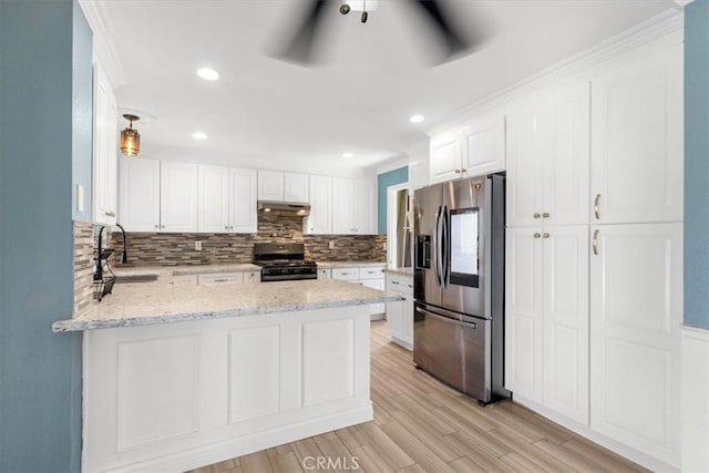 kitchen with kitchen peninsula, sink, black gas stove, white cabinetry, and stainless steel fridge with ice dispenser