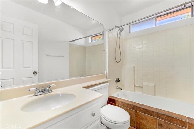 full bathroom featuring toilet, vanity, and tiled shower / bath combo