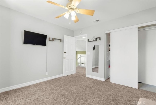 unfurnished bedroom with ceiling fan, a closet, and carpet