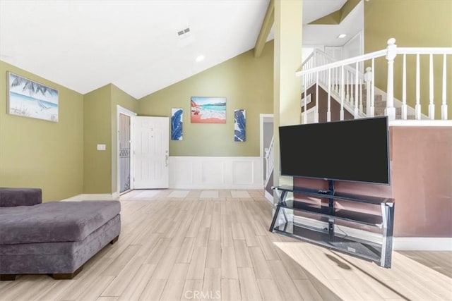 living room with light hardwood / wood-style floors and lofted ceiling