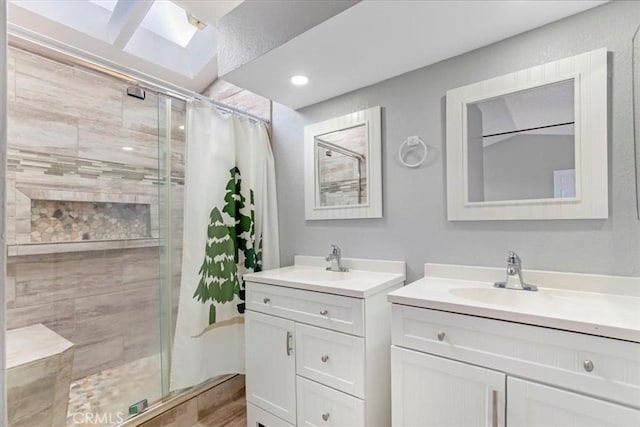 bathroom featuring a shower with shower door and vanity