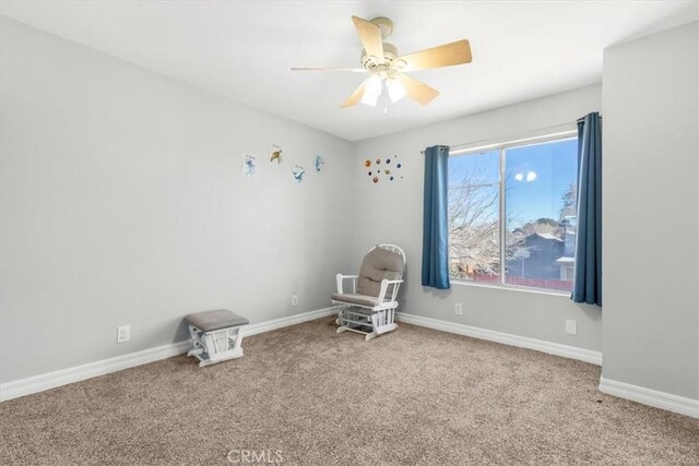 unfurnished room featuring ceiling fan and carpet flooring