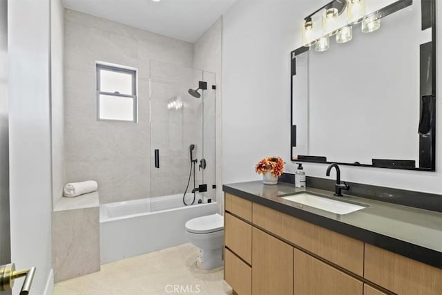 full bathroom featuring tiled shower / bath combo, vanity, and toilet