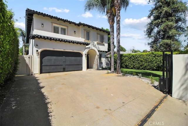 mediterranean / spanish home with a garage