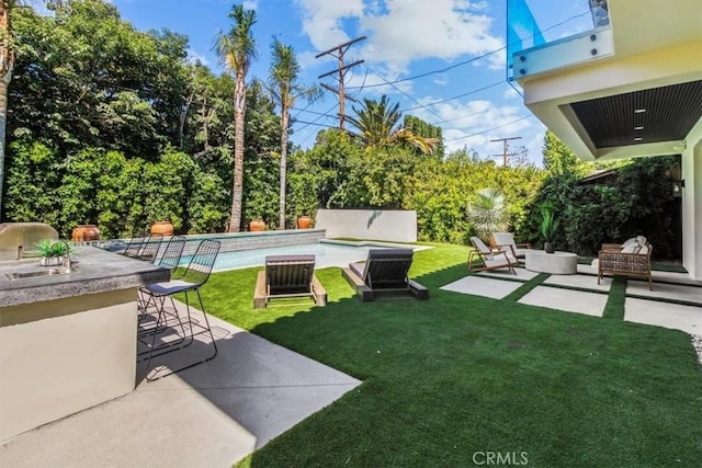 view of yard with a patio area, a bar, and an outdoor living space