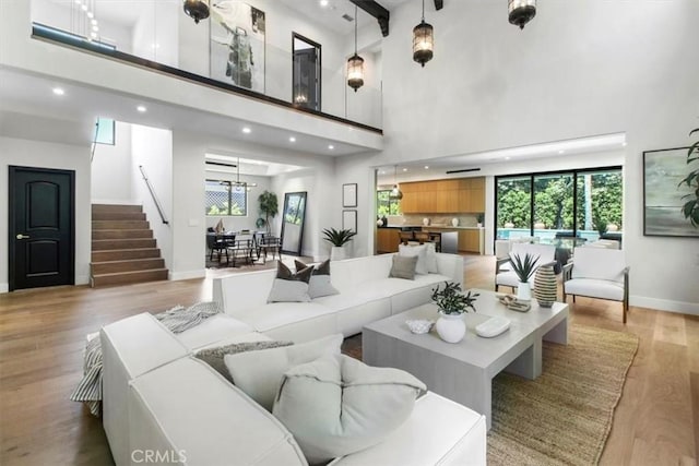 living room featuring light hardwood / wood-style floors and a towering ceiling