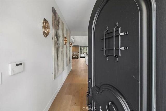 hallway with light hardwood / wood-style flooring