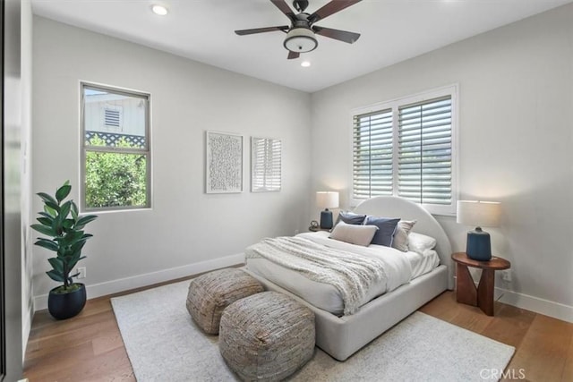 bedroom with ceiling fan and wood-type flooring