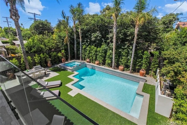 view of pool featuring a patio area, a yard, and an in ground hot tub