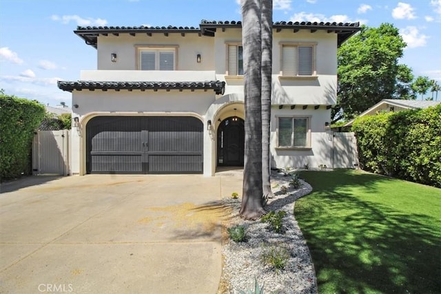 mediterranean / spanish-style house featuring a garage and a front lawn