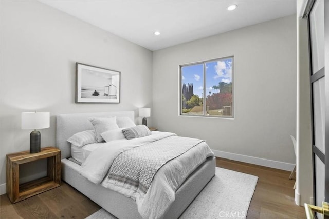 bedroom with hardwood / wood-style floors