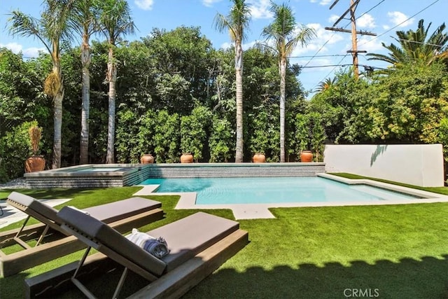 view of pool with a lawn and an in ground hot tub