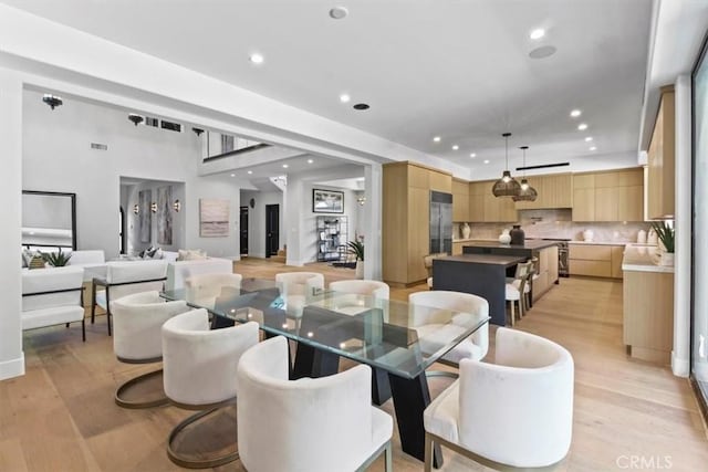 dining space with light hardwood / wood-style floors