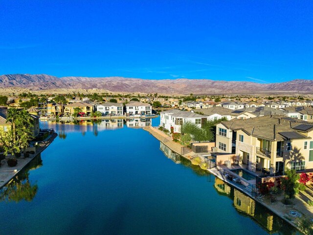 aerial view featuring a water and mountain view