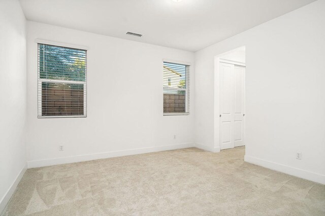 carpeted empty room with plenty of natural light