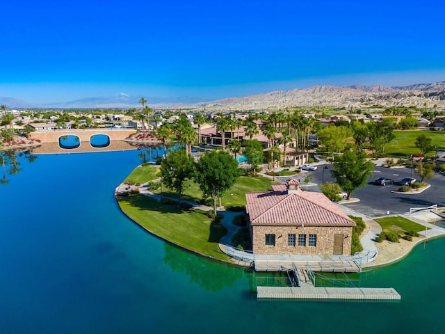 aerial view featuring a water and mountain view