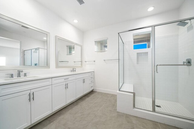 bathroom featuring tile patterned floors, walk in shower, and vanity