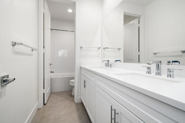 full bathroom featuring toilet, tiled shower / bath combo, vanity, and tile patterned floors