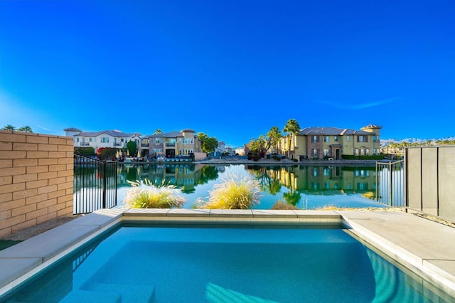 view of pool with a water view