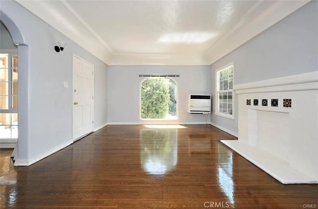 unfurnished living room with dark wood-type flooring and heating unit