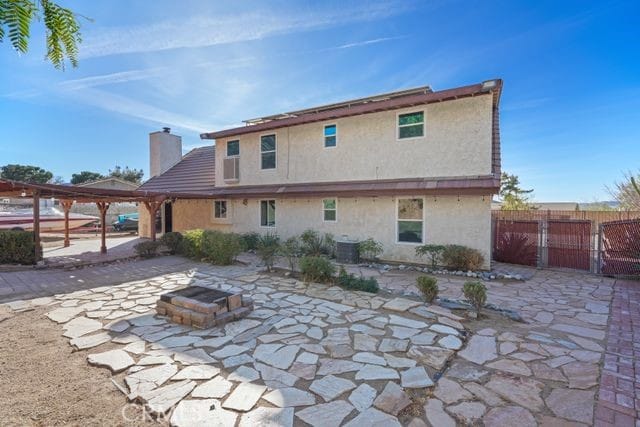 back of house with a patio area and a fire pit