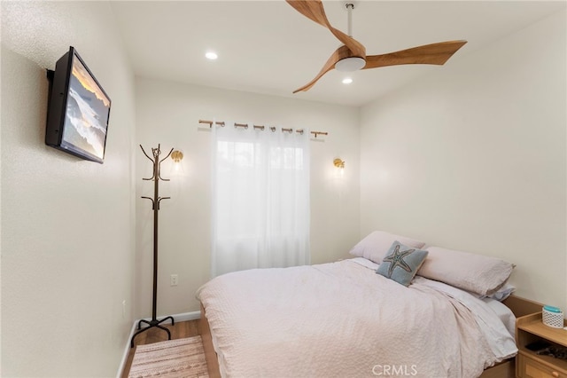 bedroom with ceiling fan and wood-type flooring