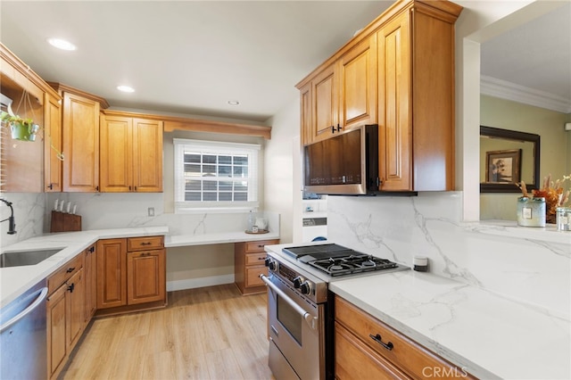 kitchen featuring light hardwood / wood-style floors, stainless steel appliances, decorative backsplash, light stone countertops, and sink