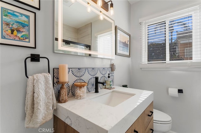 bathroom featuring toilet and vanity