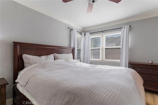 bedroom with ceiling fan, ornamental molding, and light hardwood / wood-style floors