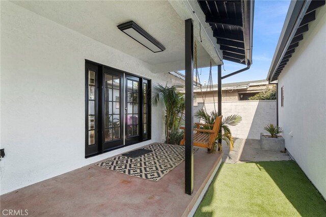 view of exterior entry featuring french doors