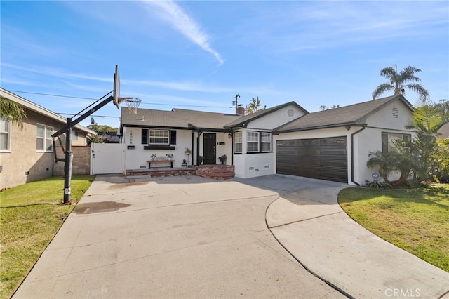 view of front of property featuring a garage and a front lawn