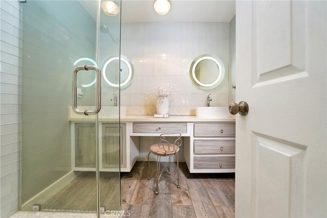 bathroom with tasteful backsplash, vanity, hardwood / wood-style floors, and an enclosed shower