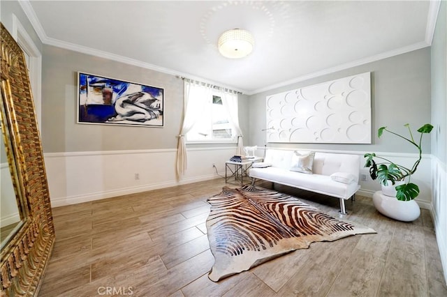 living area with ornamental molding and light hardwood / wood-style floors