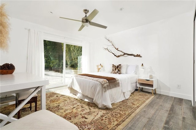 bedroom with dark wood-type flooring, ceiling fan, and access to exterior