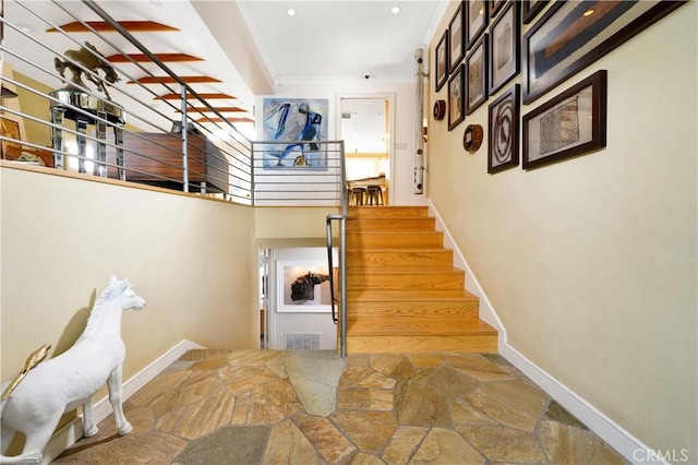 staircase featuring crown molding