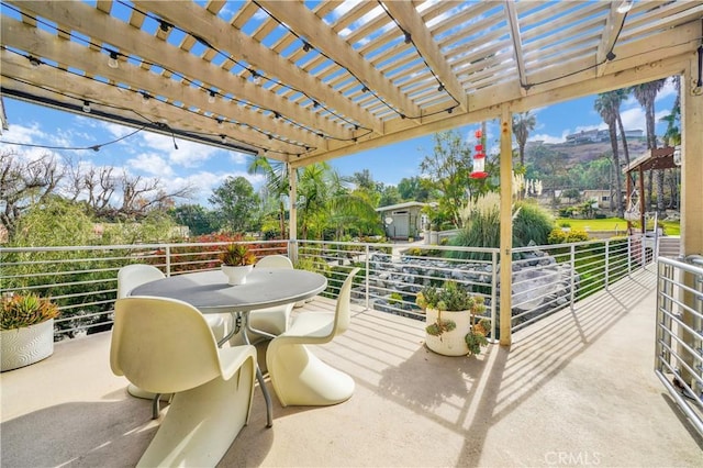 view of patio featuring a pergola and a balcony