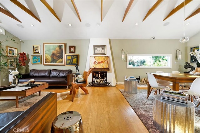 living room with hardwood / wood-style floors and lofted ceiling with beams