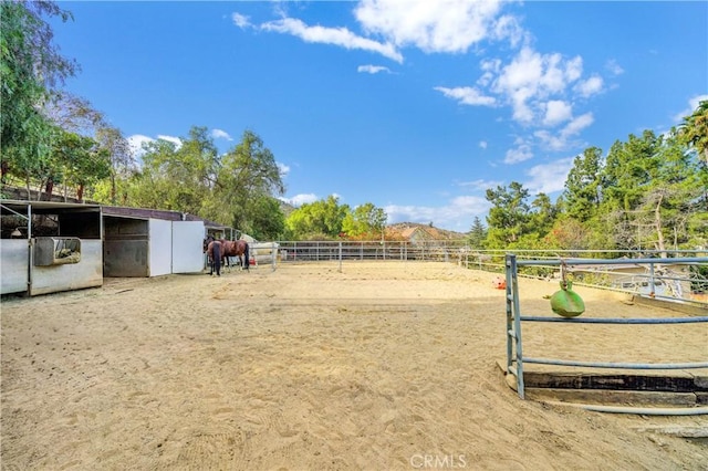 view of yard featuring a rural view and an outbuilding