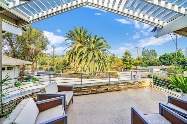 view of patio with a pergola and a balcony