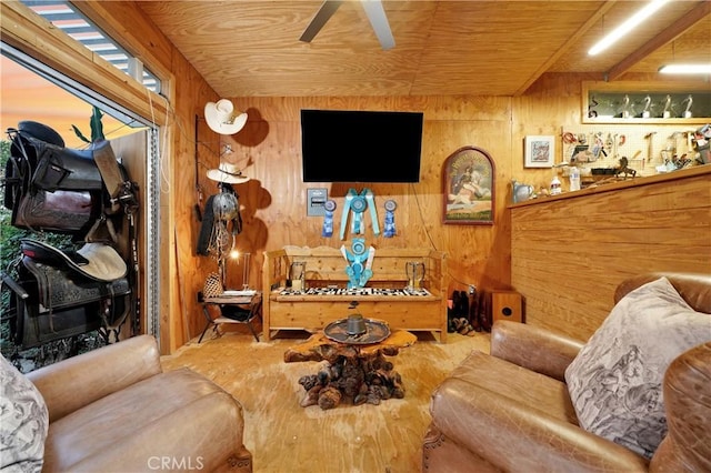 living room with ceiling fan, wood ceiling, and wooden walls