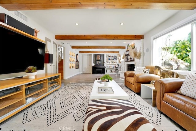 living room with light hardwood / wood-style floors and beam ceiling