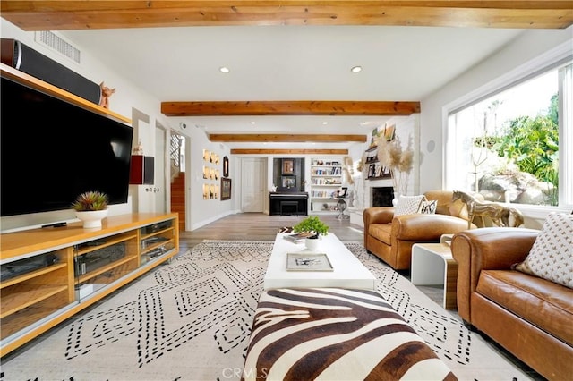 living room with beam ceiling and light hardwood / wood-style floors