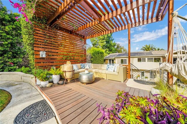 wooden deck with an outdoor hangout area and a pergola