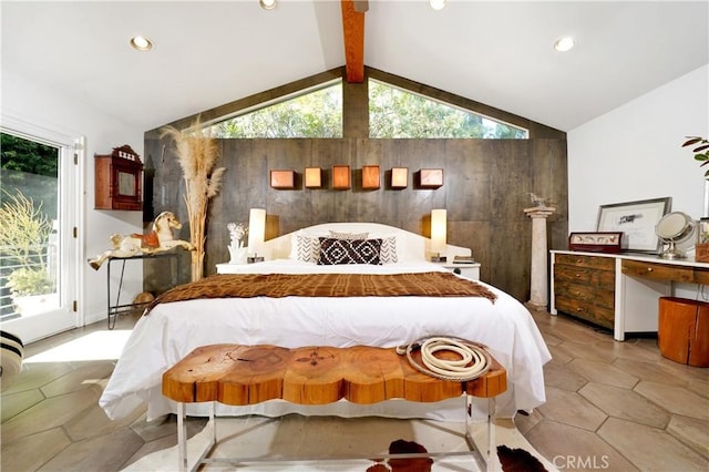 bedroom with access to outside and vaulted ceiling with beams