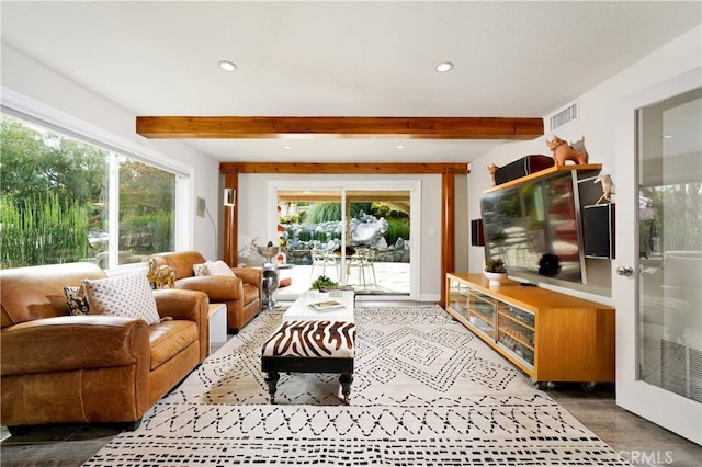 living room with beamed ceiling and dark wood-type flooring