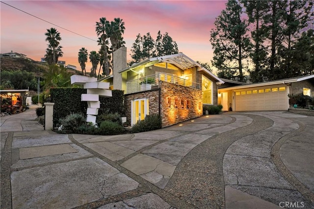 view of front of property with a garage and a balcony