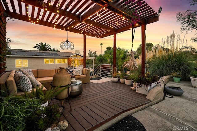 patio terrace at dusk featuring outdoor lounge area and a pergola